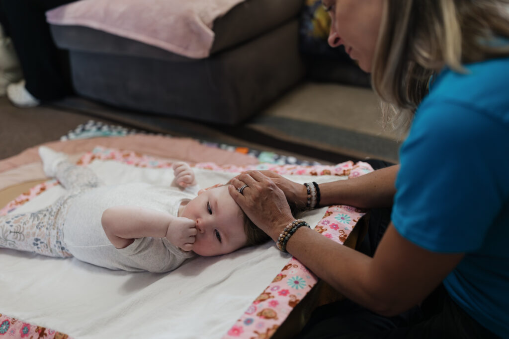 Clinician stroking baby's head