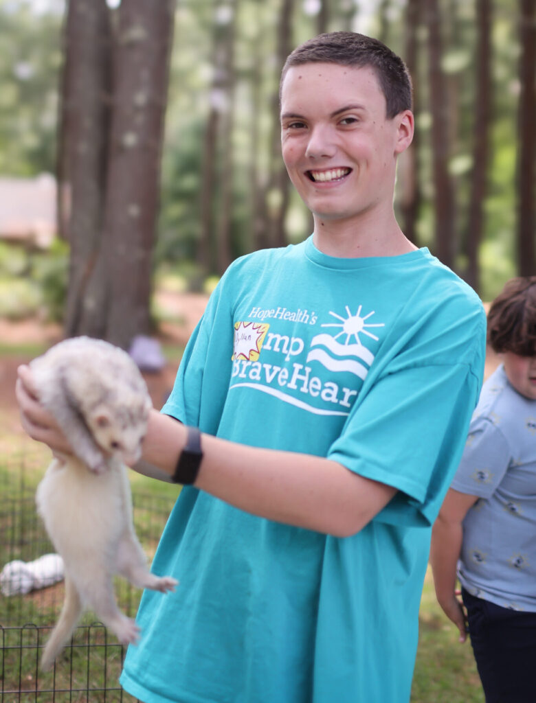 Teenage boy holding up a bunny rabbit