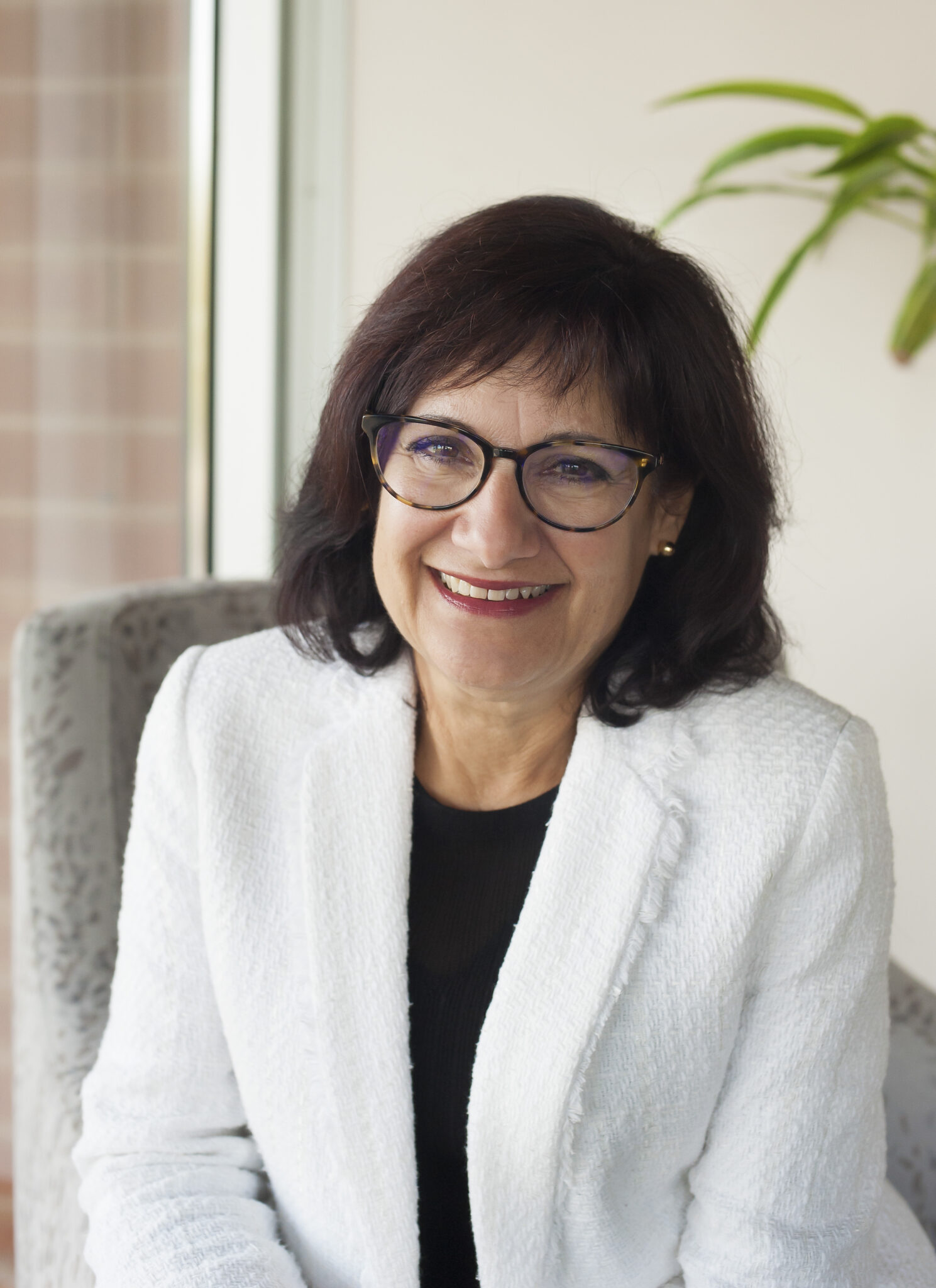 woman in black shirt and white blazer