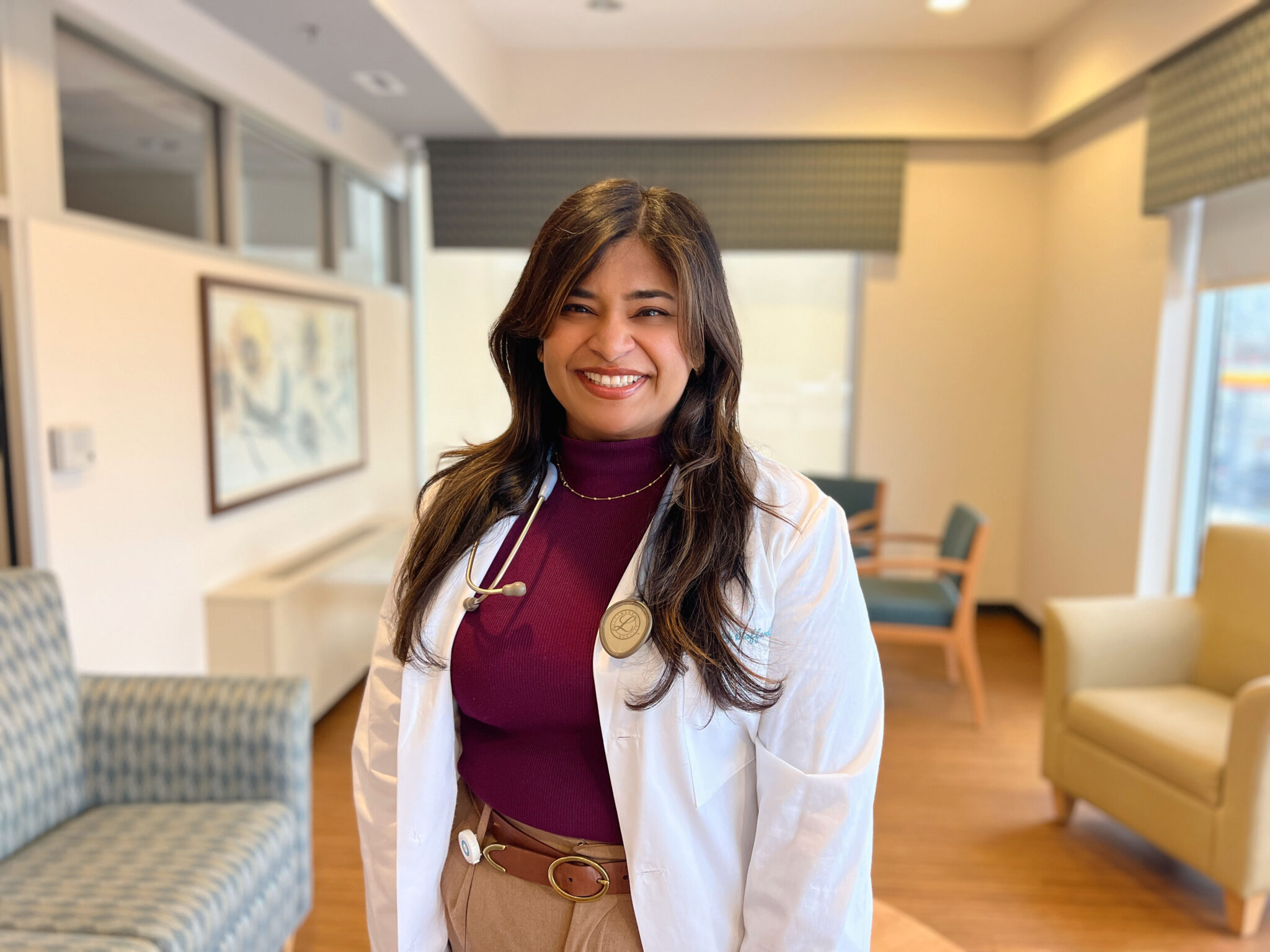 Female palliative care doctor standing with a white lab coat on