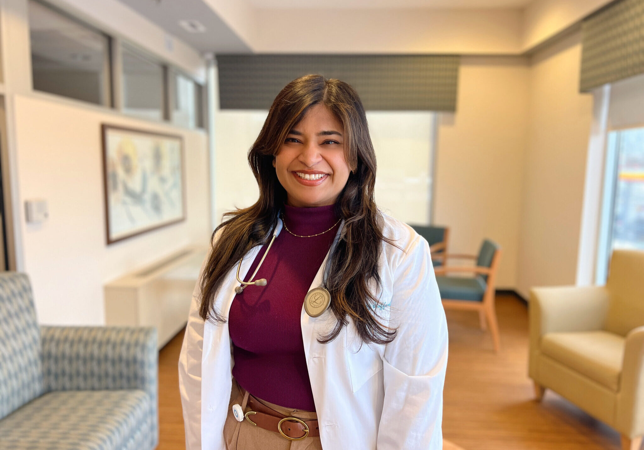 Female palliative care doctor standing with a white lab coat on