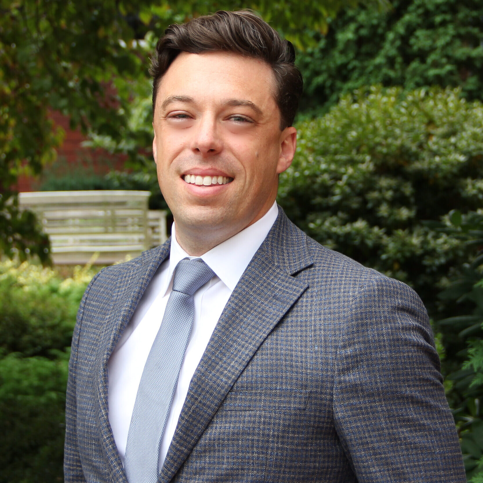 Man in grey business suit and blue tie